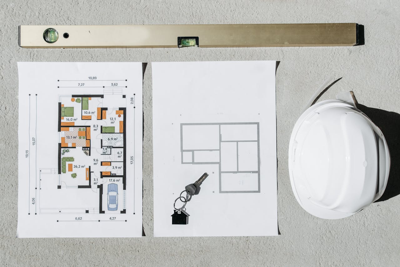 Services Blueprints, spirit level, and hard hat symbolize house planning.